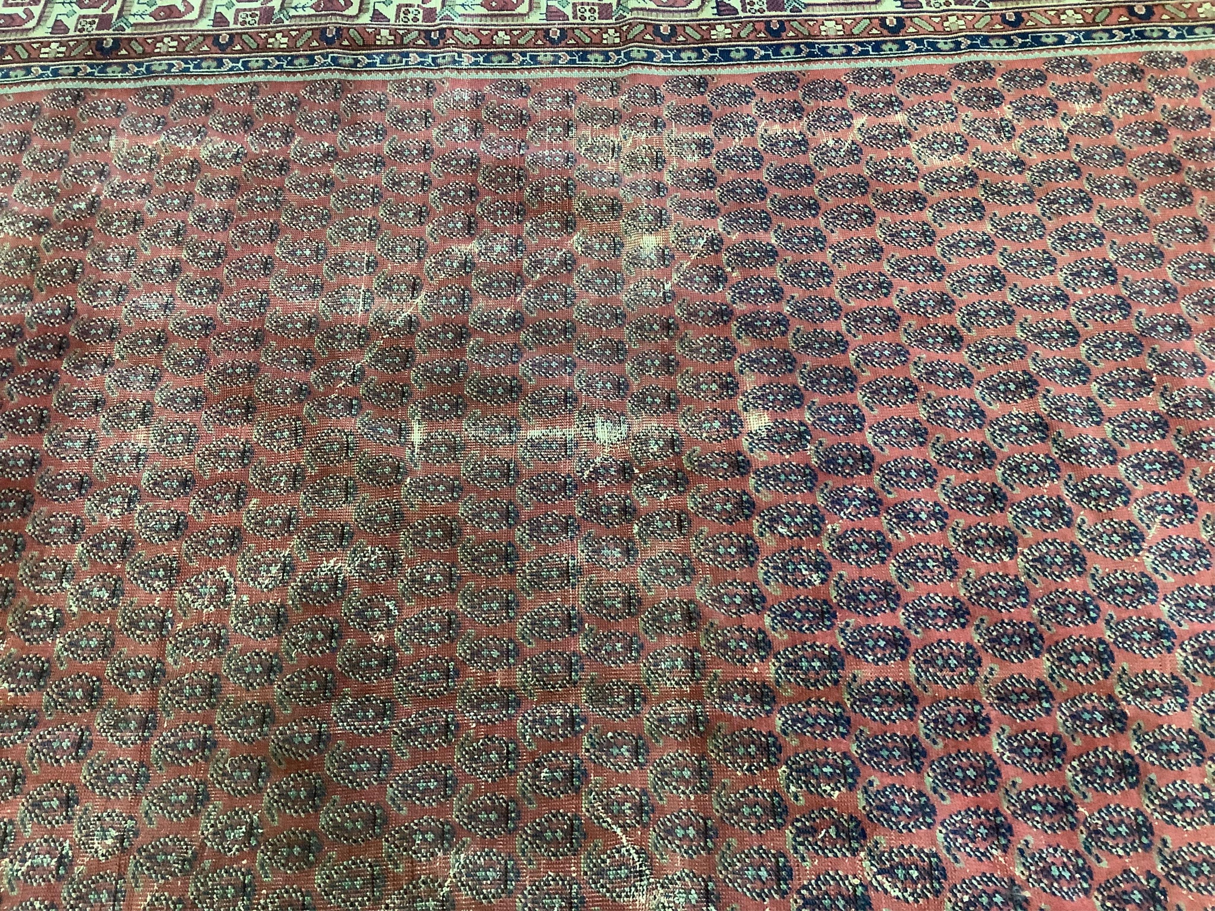 A Salouk red ground carpet, 350 x 265cm. Condition - poor to fair